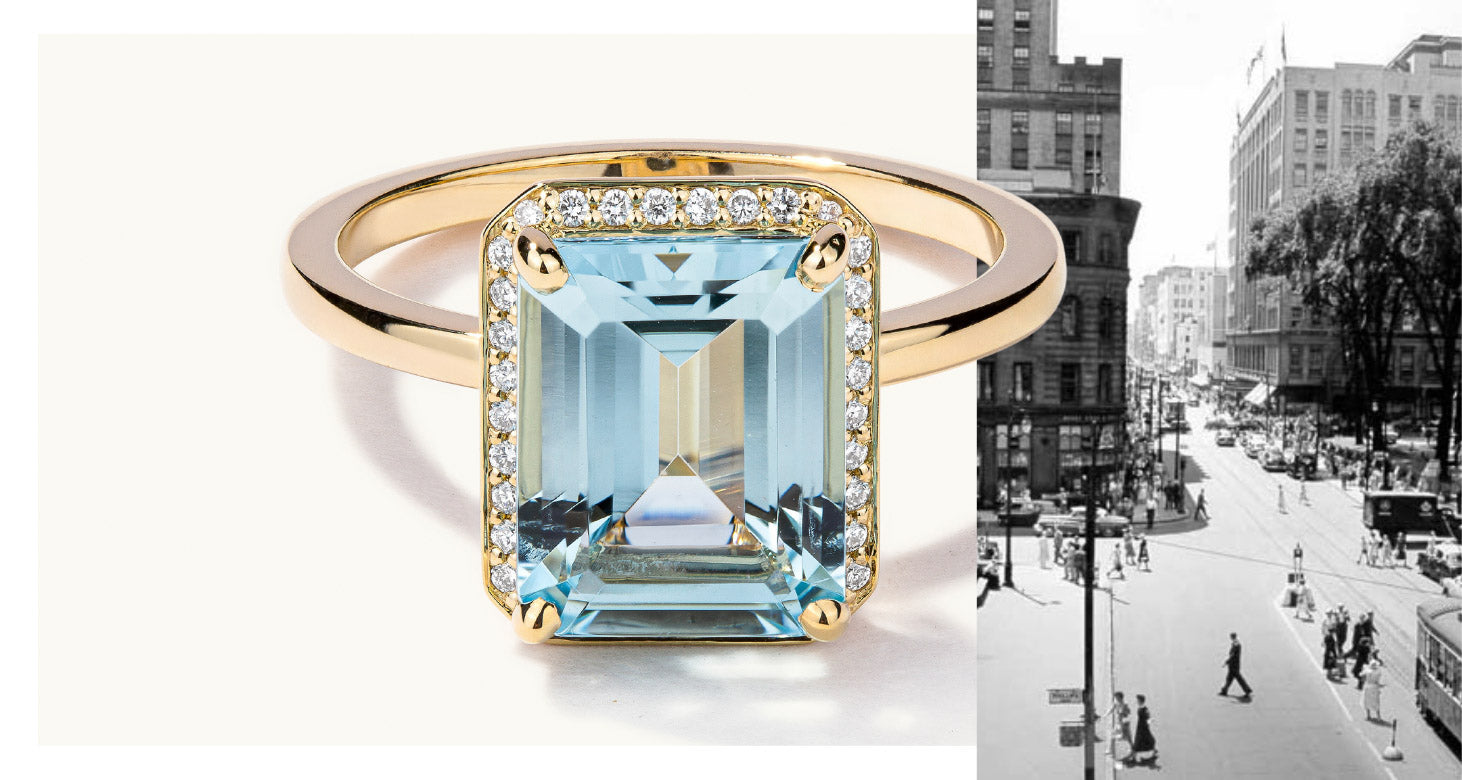 18K yellow gold engagement ring featuring an emerald-cut gemstone with a diamond halo. Canadian-made in Montreal.