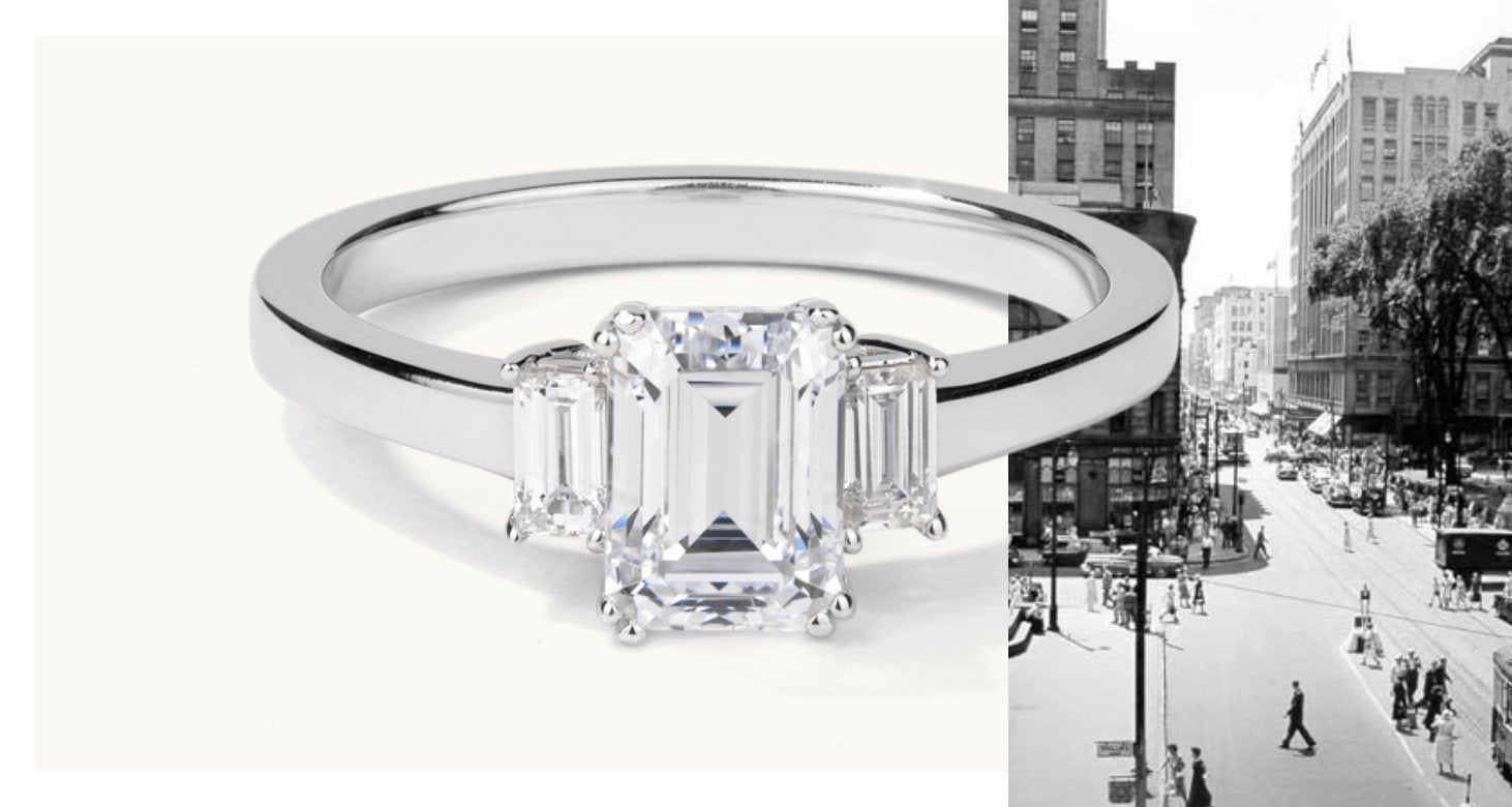 A Canadian-made three-stone engagement ring with emerald-cut diamonds on a classic 18K white gold band.