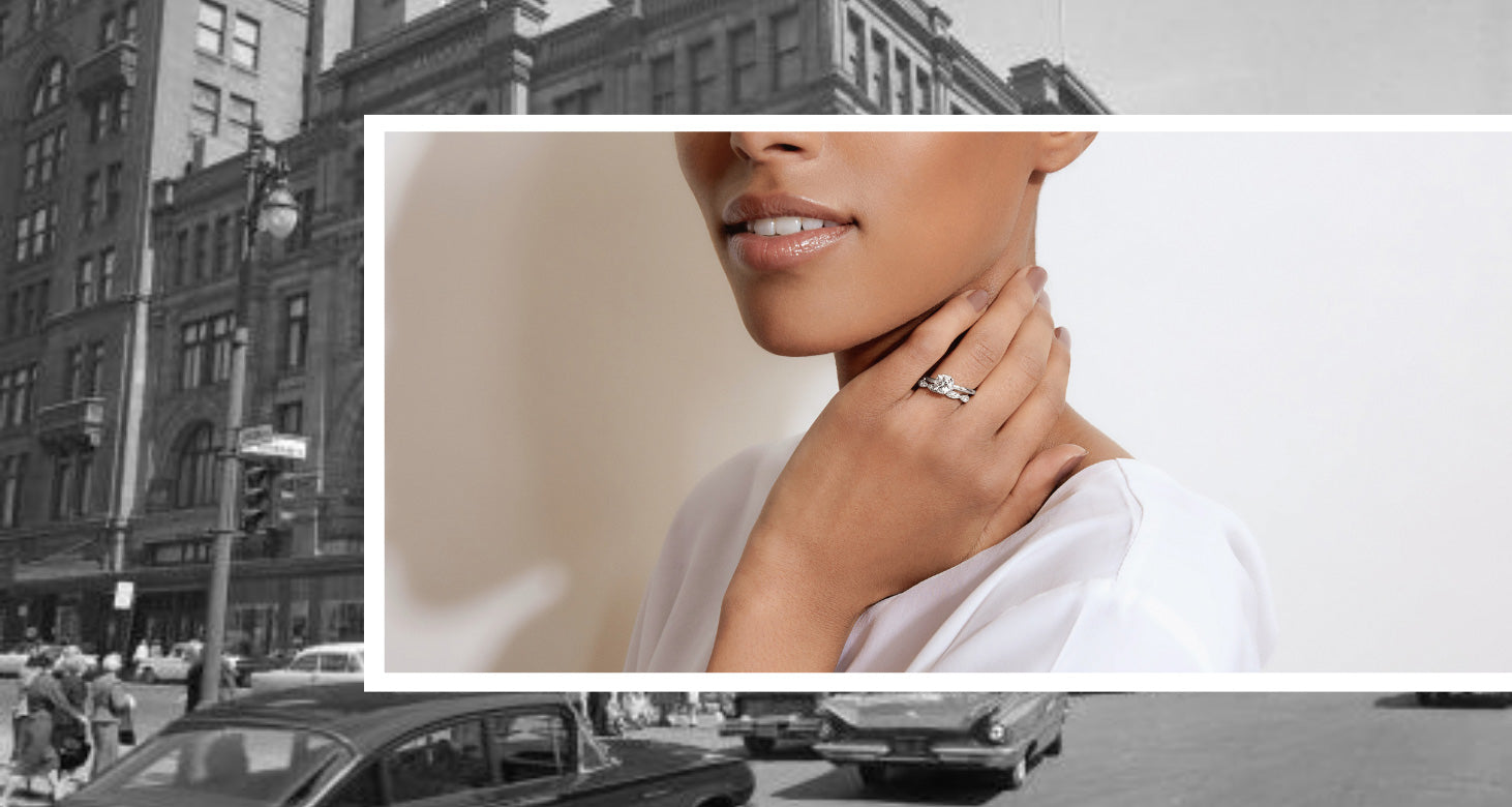 A Canadian-made diamond engagement ring and wedding band set in 18K white gold, worn against a vintage Montreal backdrop.