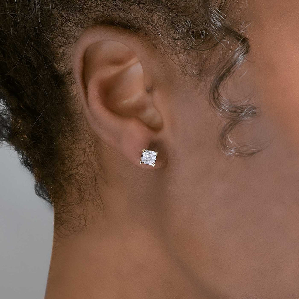 Model wearing Jewellers District's Asscher-Cut Diamond Stud Earrings in 14k Yellow Gold, Lab-grown 1.40 ctw, VS2+/ F+ #3