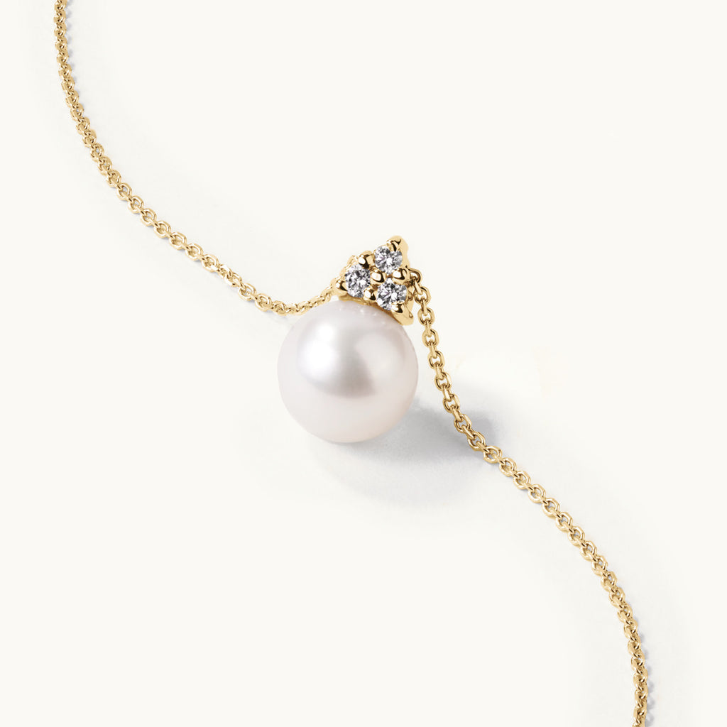 Angled view of Jewellers District's Freshwater Pearl Pendant Necklace with Accent Diamonds in 14k Yellow Gold