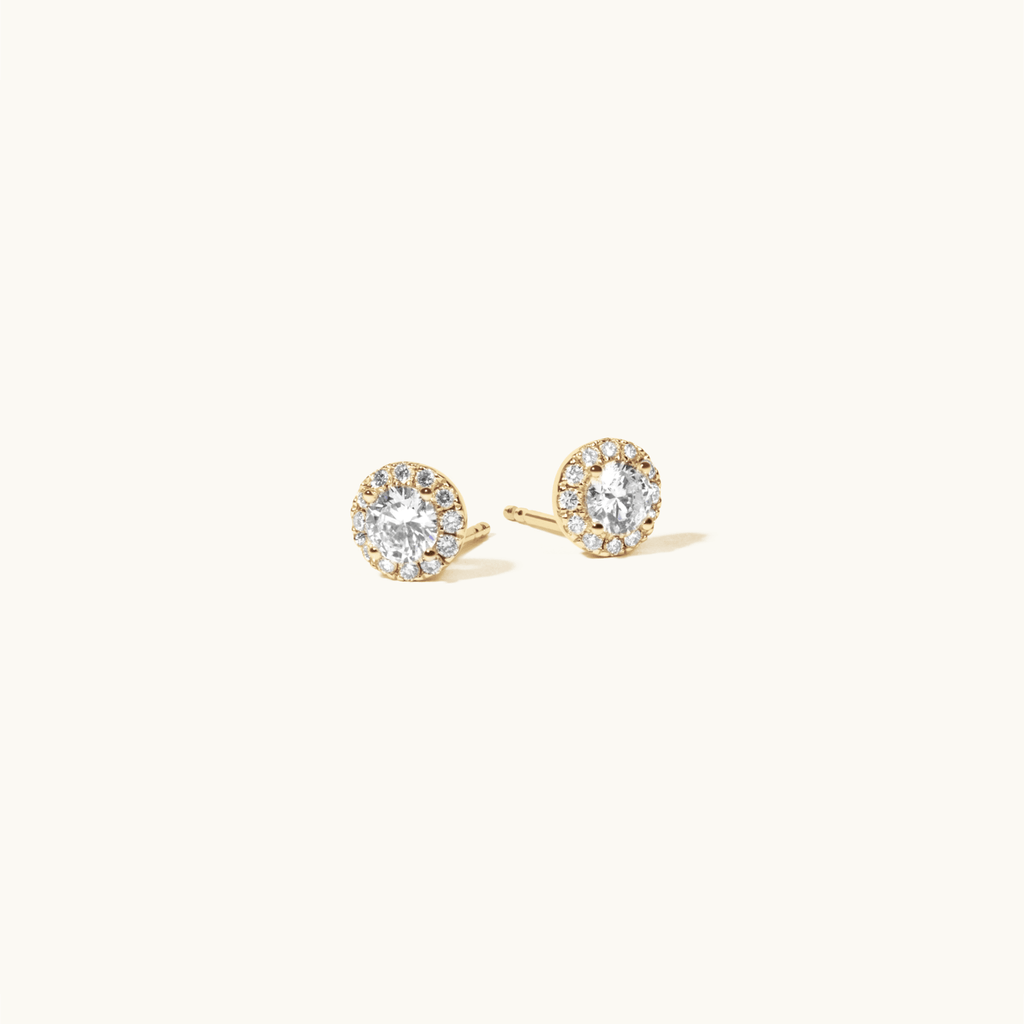 Angled view of Jewellers District's Diamond Halo Stud Earrings in 14k Yellow Gold