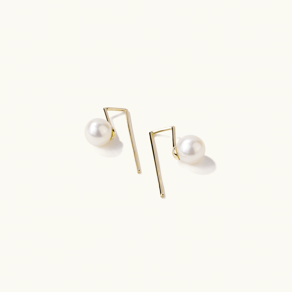 Angled view of Jewellers District's Freshwater Pearl Drop Earrings in 14k Yellow Gold