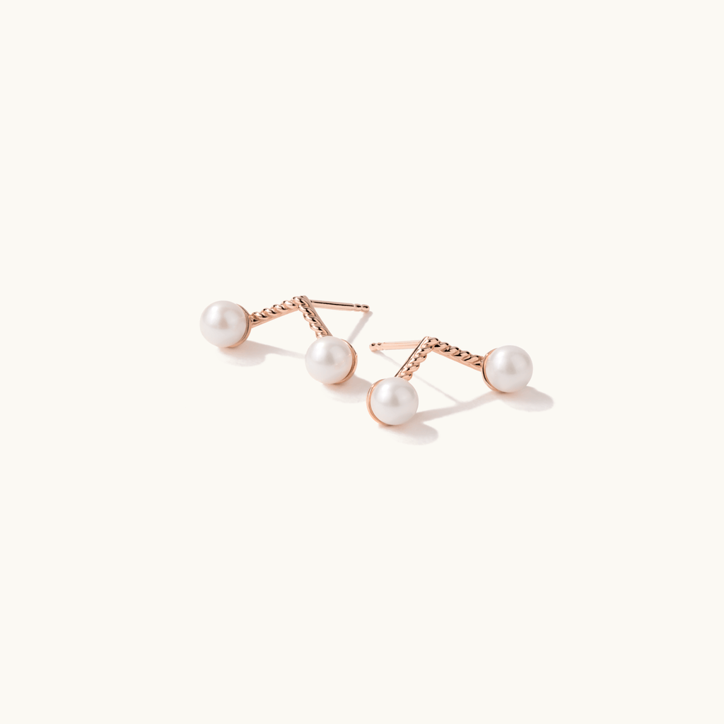 Angled view of Jewellers District's Cherry Stem Freshwater Pearl Earrings in 10k Rose Gold