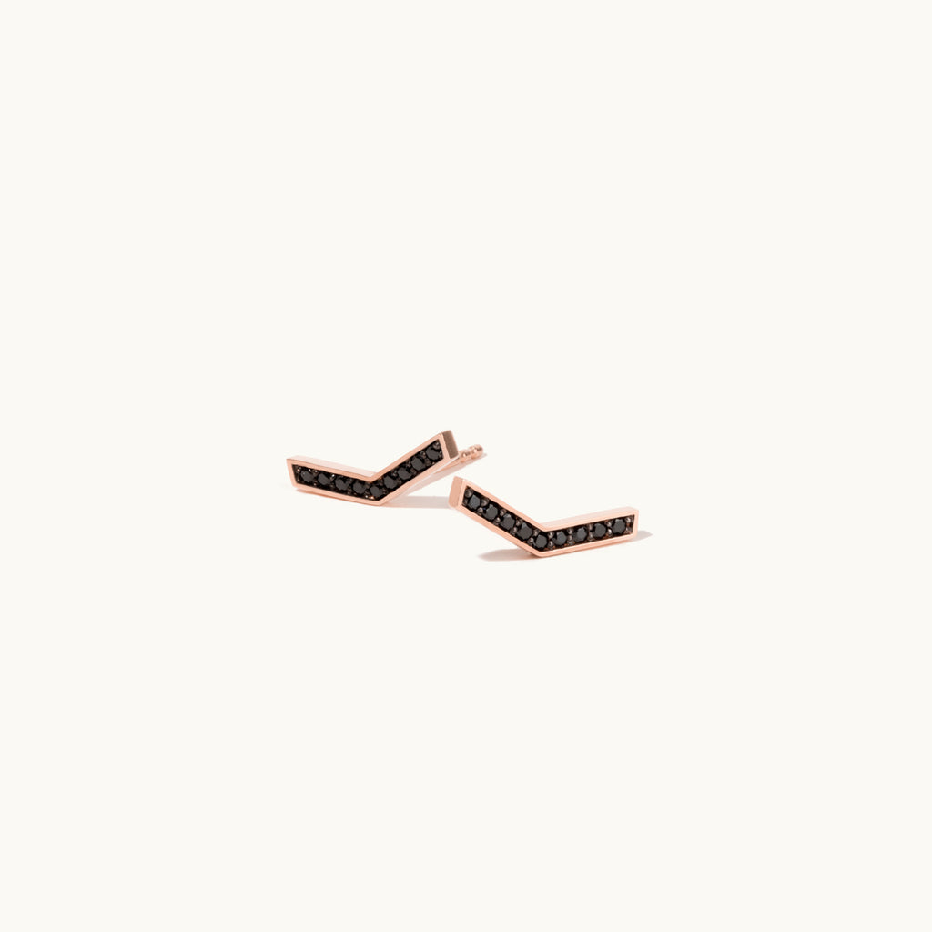 Angled view of Jewellers District's V-Shaped Stud Earrings with Accent Black Spinels in 14k Rose Gold