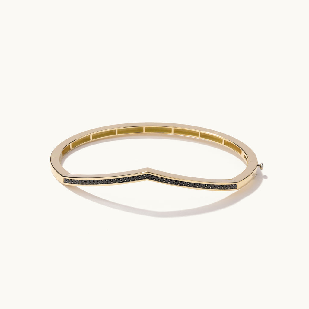 Face view of Jewellers District's V-Shaped Gold Bangle with Black Spinels in 14k Yellow Gold