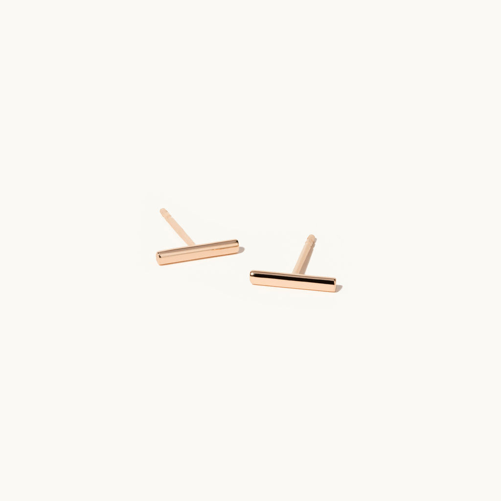 Angled view of Jewellers District's Gold Bar Stud Earrings in 14k Rose Gold