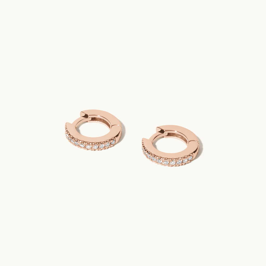 Angled view of Jewellers District's Petite Diamond Hoop Earrings in 14k Rose Gold