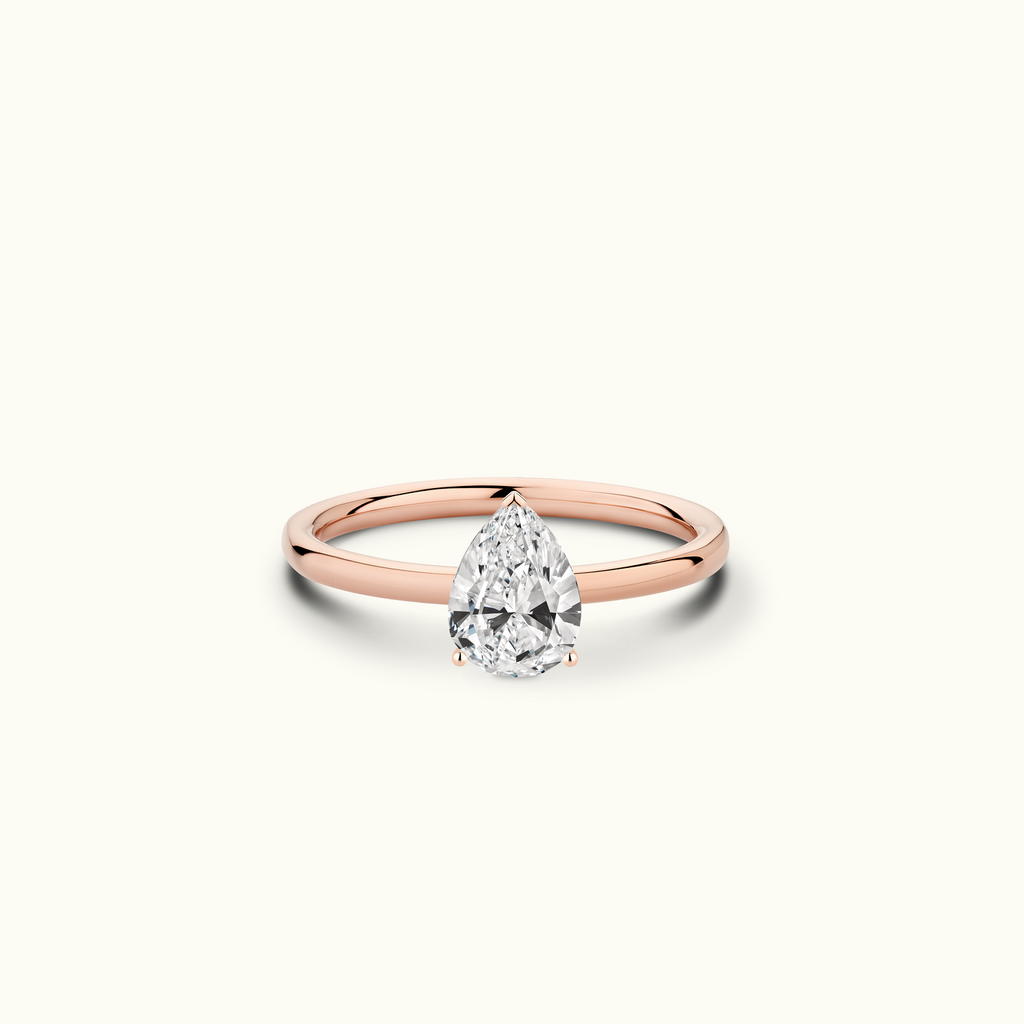 Jewellers District's Solitaire Diamond Engagement Ring with Signature Knot-Basket in 14k Rose Gold, Pear