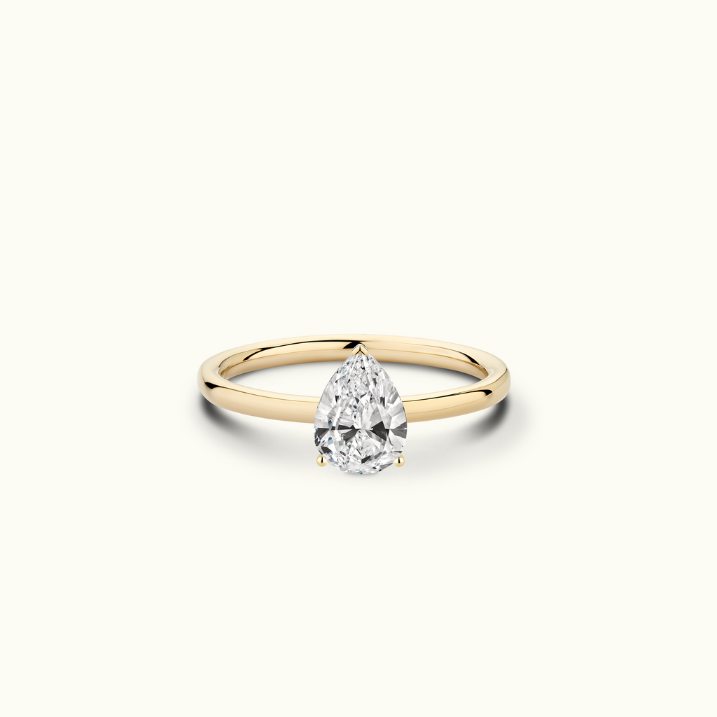 Jewellers District's Solitaire Diamond Engagement Ring with Signature Knot-Basket in 14k Yellow Gold, Pear