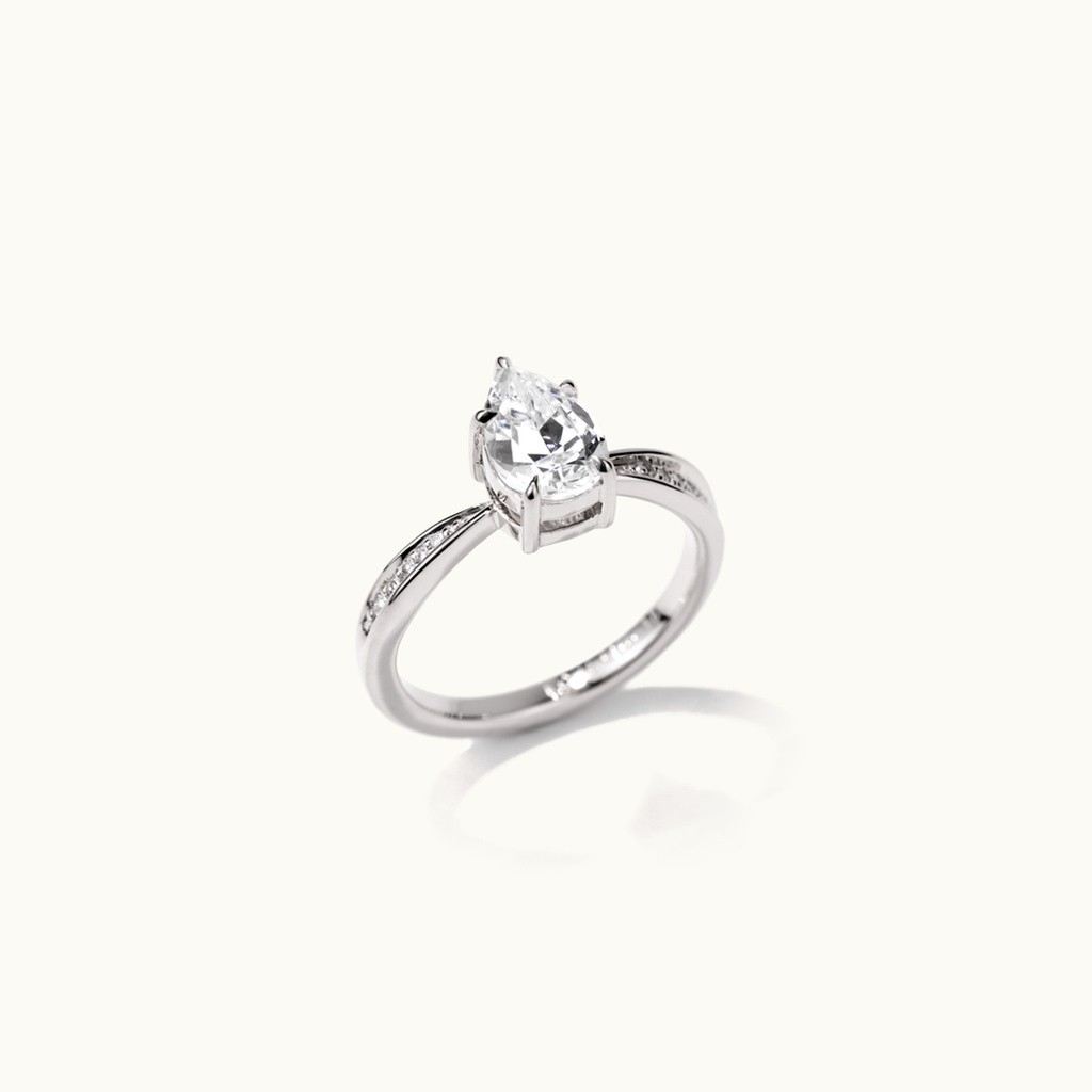 Angled view of Jewellers District's Five-Prong Diamond Engagement Ring with Diamond Pavé in 14k White Gold, Pear