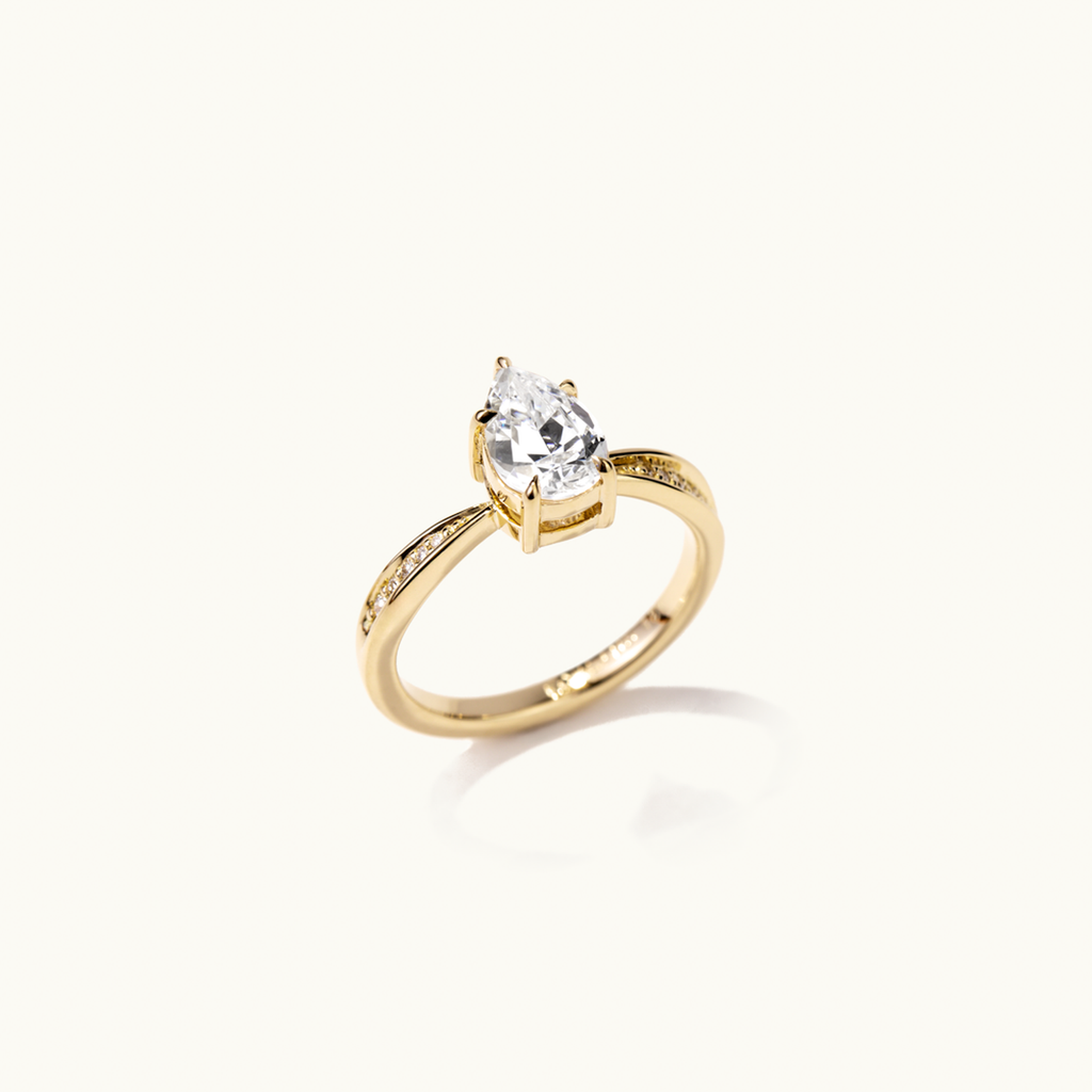 Angled view of Jewellers District's Five-Prong Diamond Engagement Ring with Diamond Pavé in 14k Yellow Gold, Pear