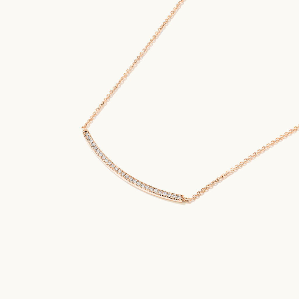 Profile view of Jewellers District's Curved Diamond Bar Necklace in 14k Rose Gold