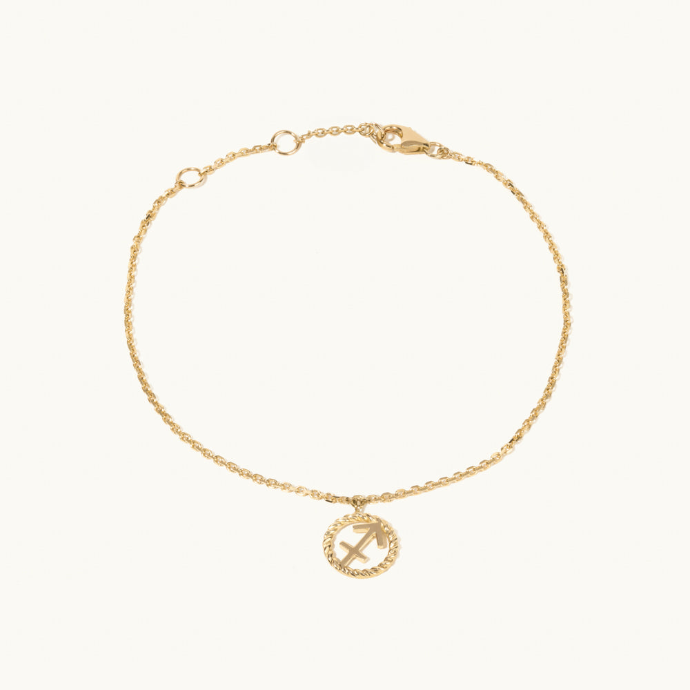 Model wearing Jewellers District's Gold Zodiac Charm Bracelet: Sagittarius in 14k Yellow Gold