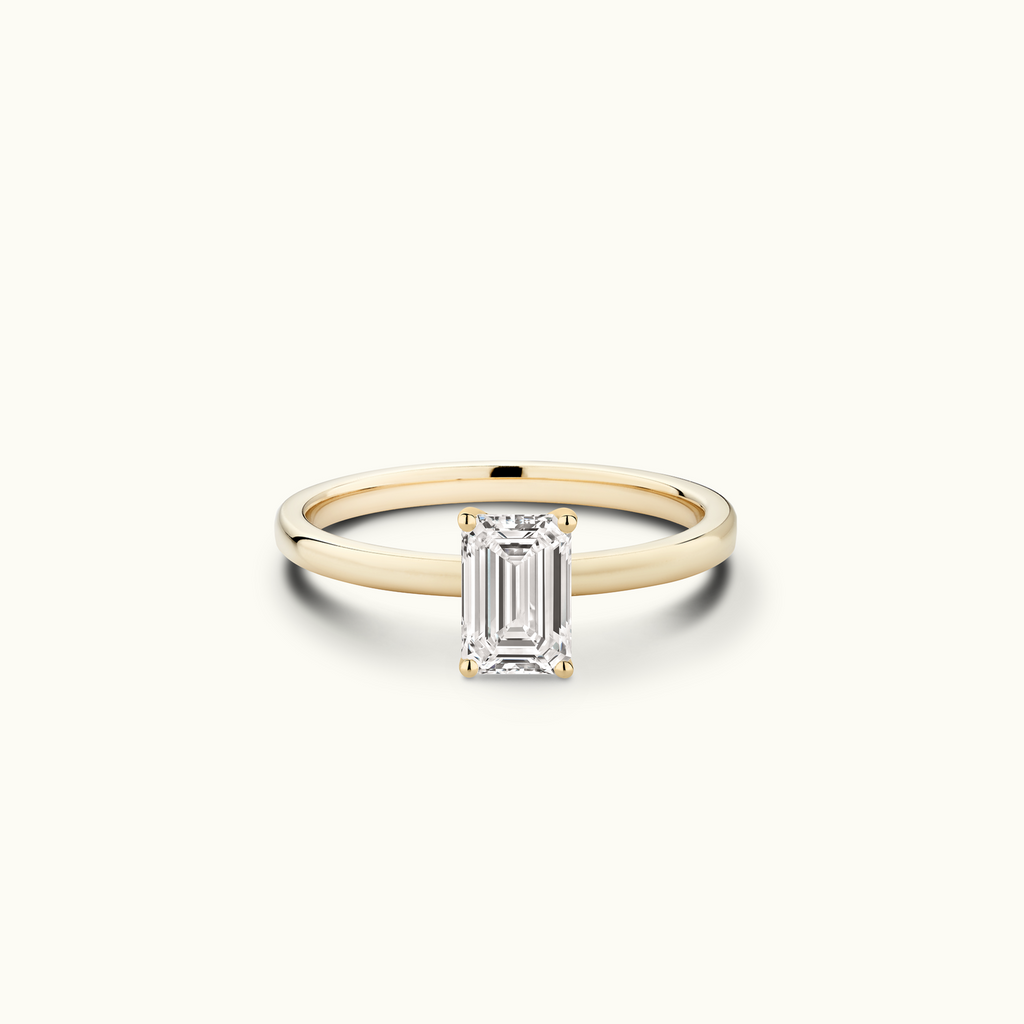 Jewellers District's Diamond Engagement Ring with Signature Knot-Basket and Accent Diamonds in 14k Yellow Gold, Emerald