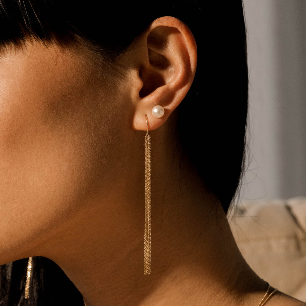 Model wearing Jewellers District's Gold Tassel Dangle Earrings in 14k Yellow Gold #2