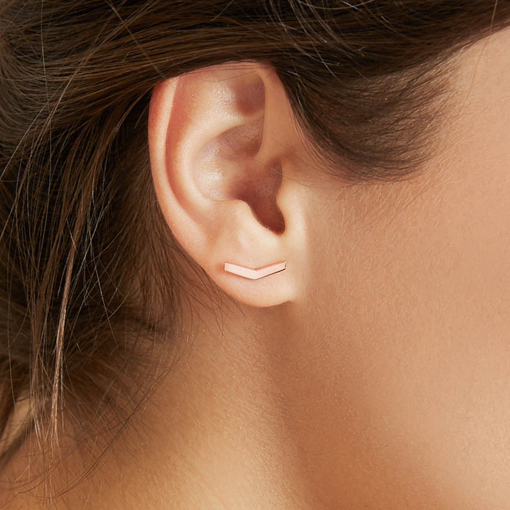 Model wearing Jewellers District's V-Shaped Gold Stud Earrings in 10k Rose Gold