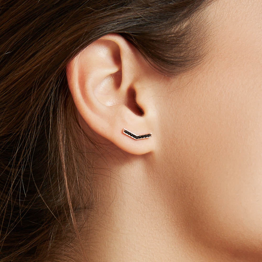 Model wearing Jewellers District's V-Shaped Stud Earrings with Accent Black Spinels in 14k Rose Gold