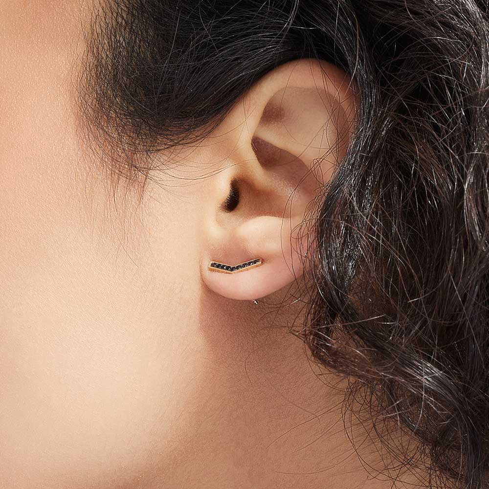 Model wearing Jewellers District's V-Shaped Stud Earrings with Accent Black Spinels in 14k Yellow Gold #3