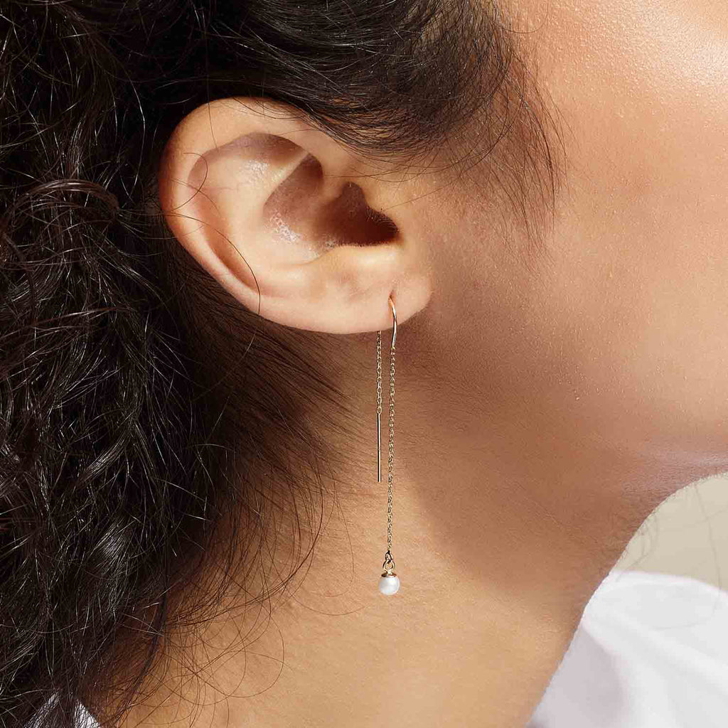 Model wearing Jewellers District's Freshwater Pearl Threader Earrings in 14k Yellow Gold #3