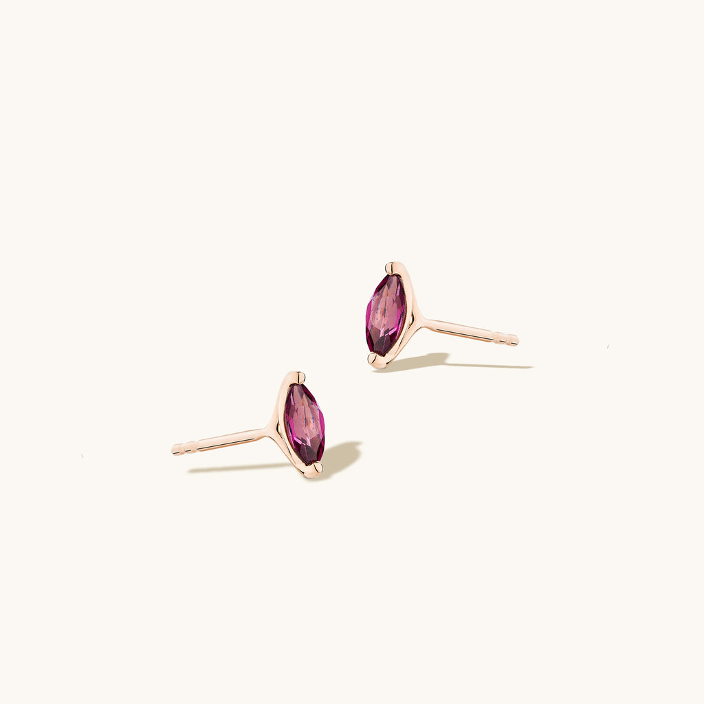 Angled view of Jewellers District's Marquise Cut Garnet Studs in 14k Rose Gold