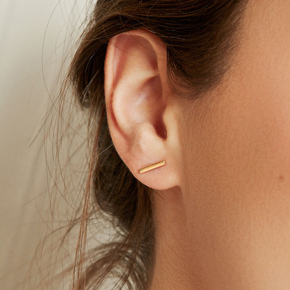 Model wearing Jewellers District's Gold Bar Stud Earrings in 10k Yellow Gold #3