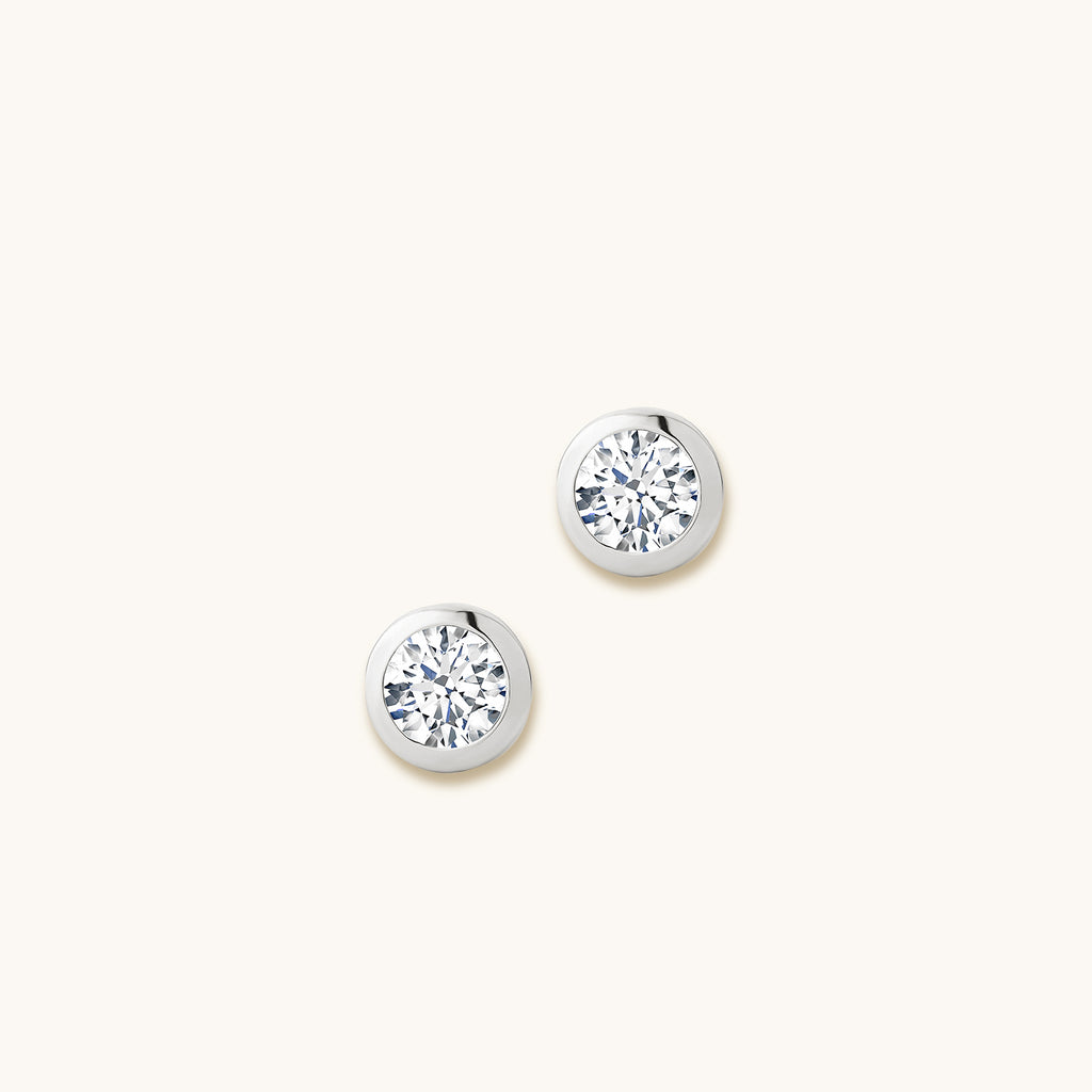 Face view of Jewellers District's Bold Bezel-Set Round Cut Diamond Studs in 14k White Gold