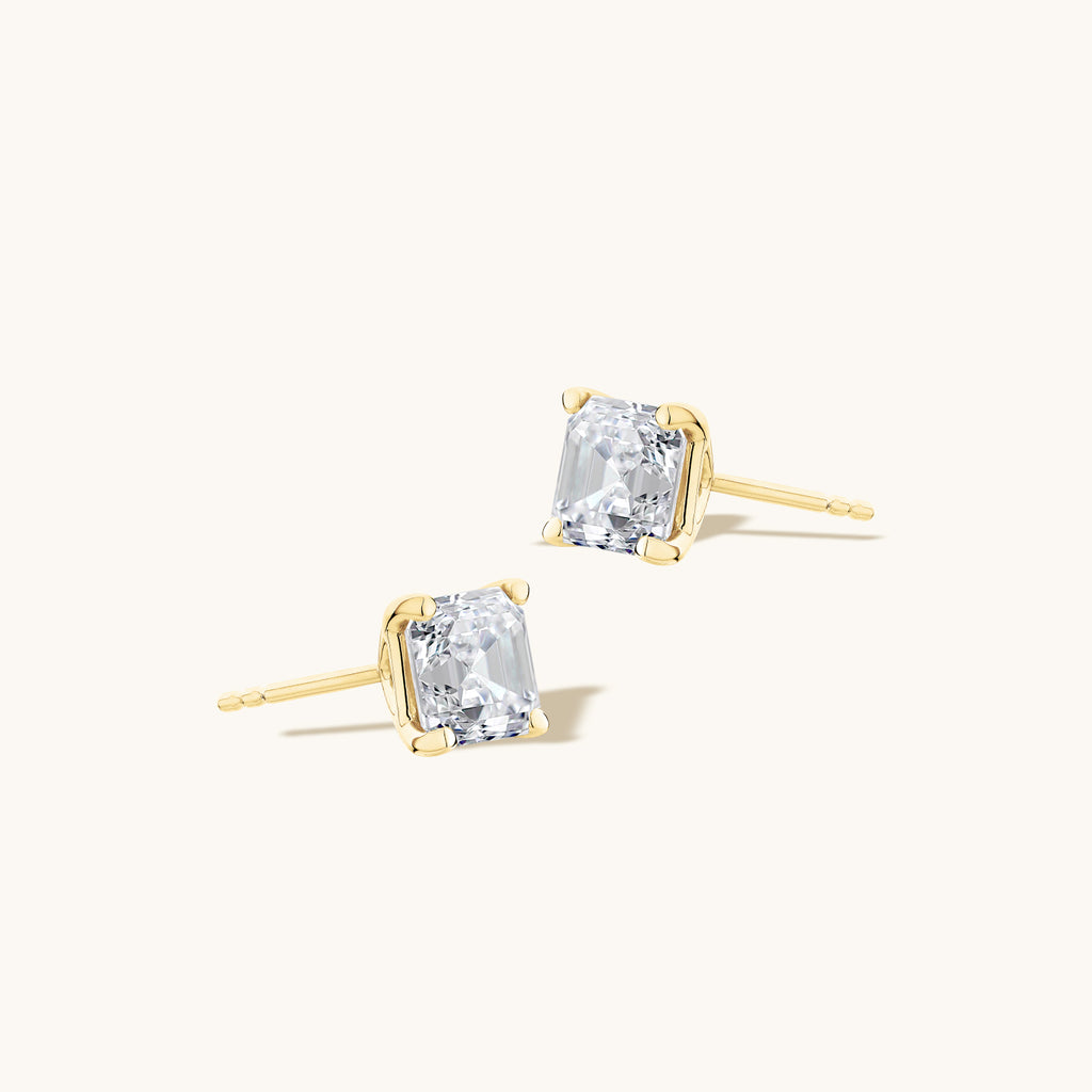 Angled view of Jewellers District's Asscher-Cut Diamond Stud Earrings in 14k Yellow Gold, Lab-grown 1.40 ctw, VS2+/ F+