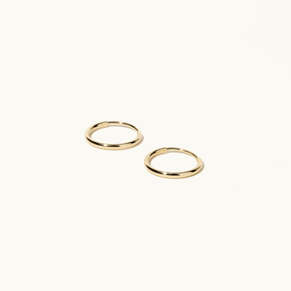 Profile view of Jewellers District's Petite Gold Hoop Earrings in 14k Yellow Gold