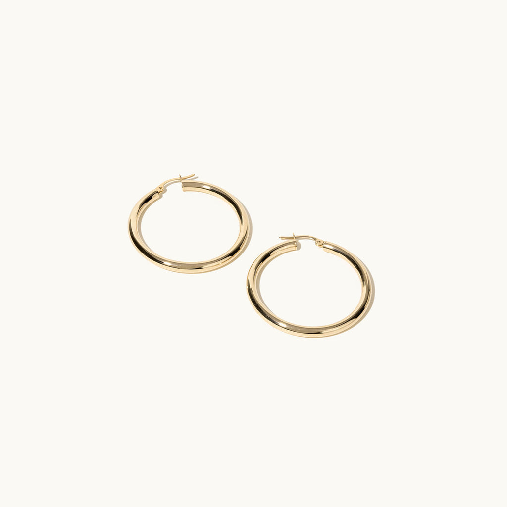 Profile view of Jewellers District's Thin Gold Hoop Earrings in 14k Yellow Gold