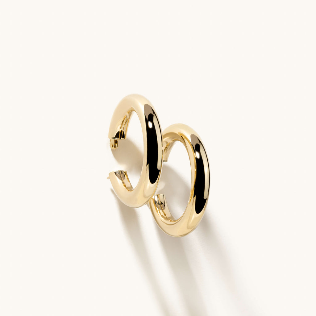 Angled view of Jewellers District's Bold Gold Hoop Earrings in 14k Yellow Gold