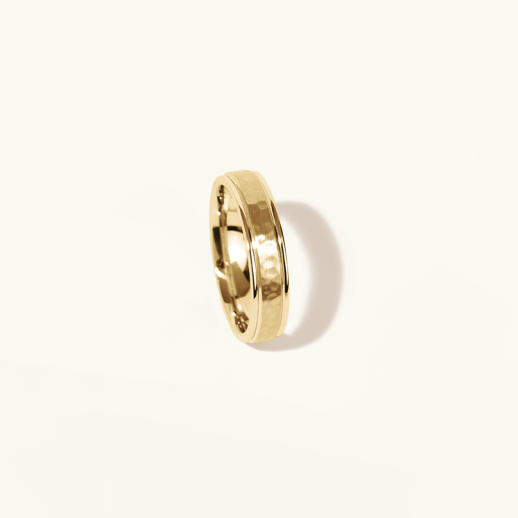 Profile view of Jewellers District's Hammered Wedding Ring in 14k Yellow Gold