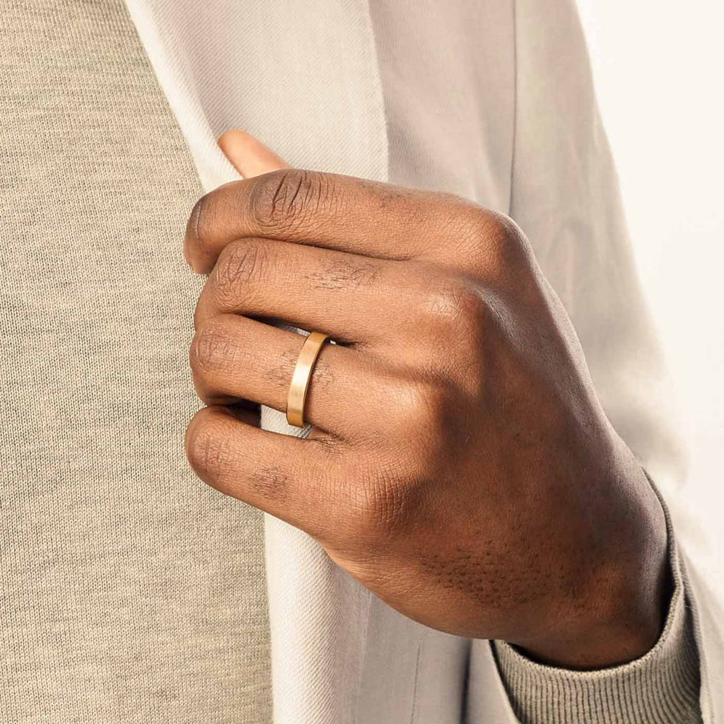 Model wearing Jewellers District's Flat Brushed Wedding Ring in 14k Yellow Gold, Band: 5mm #2