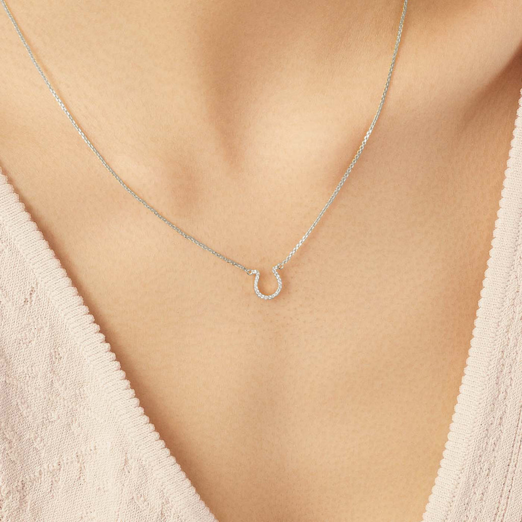 Model wearing Jewellers District's Horseshoe Diamond Pavé Pendant Necklace in 10k White Gold #2