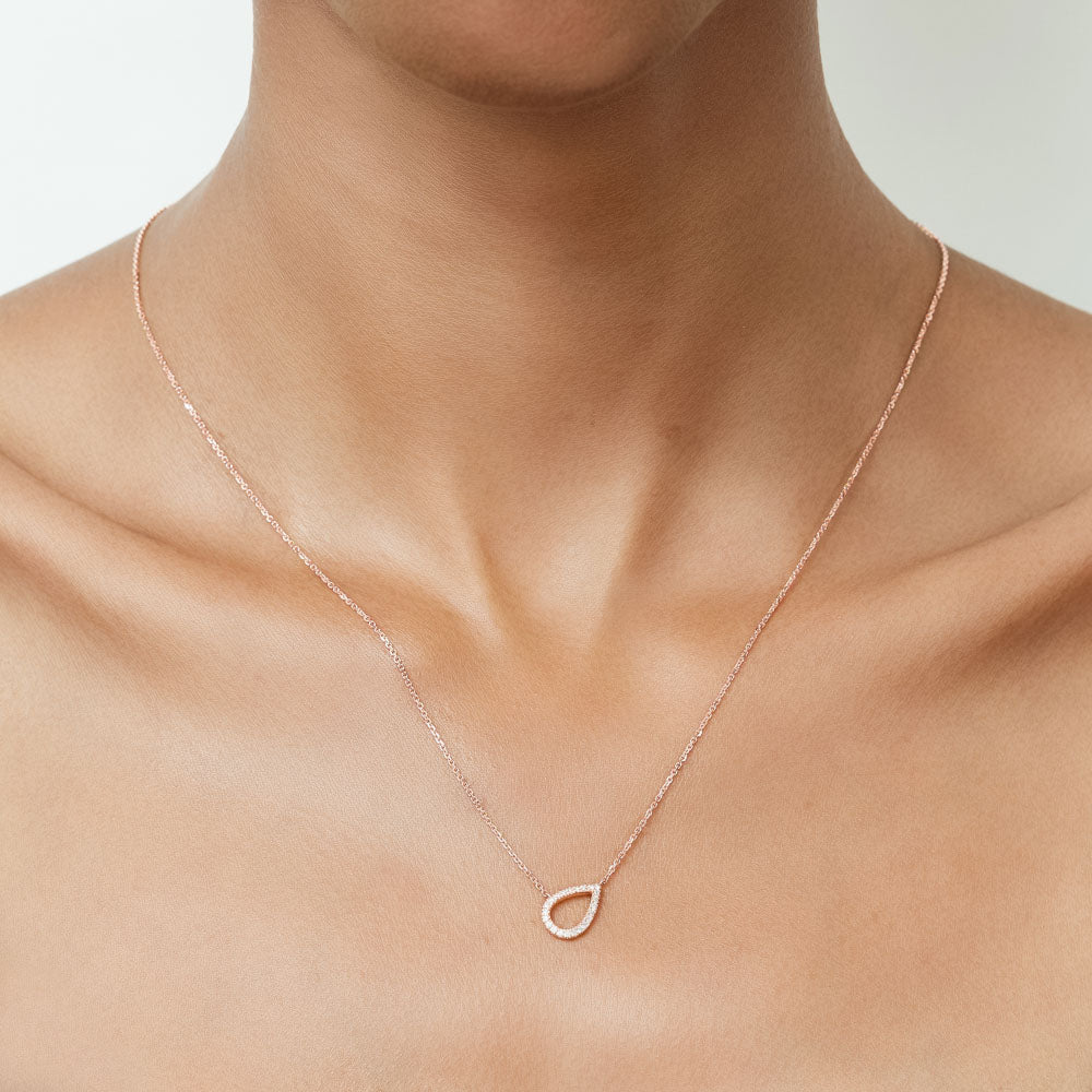 Model wearing Jewellers District's Pear Diamond Pavé Pendant Necklace in 10k Rose Gold