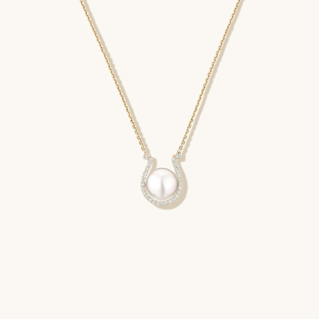 Face view of Jewellers District's Horseshoe Freshwater Pearl Pendant Necklace with Diamond Pavé in 14k Yellow Gold