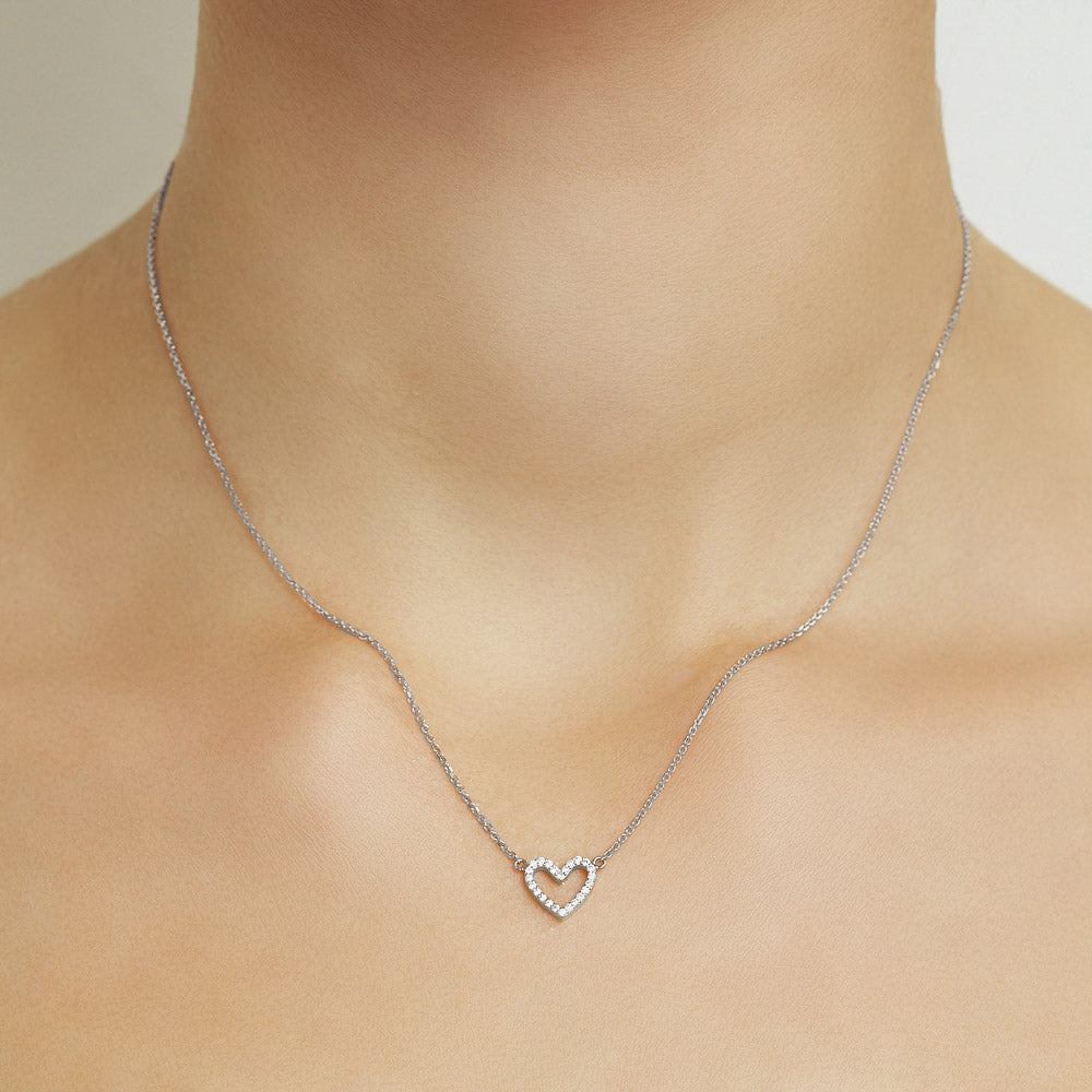 Model wearing Jewellers District's Heart Diamond Pavé Pendant Necklace in 10k White Gold