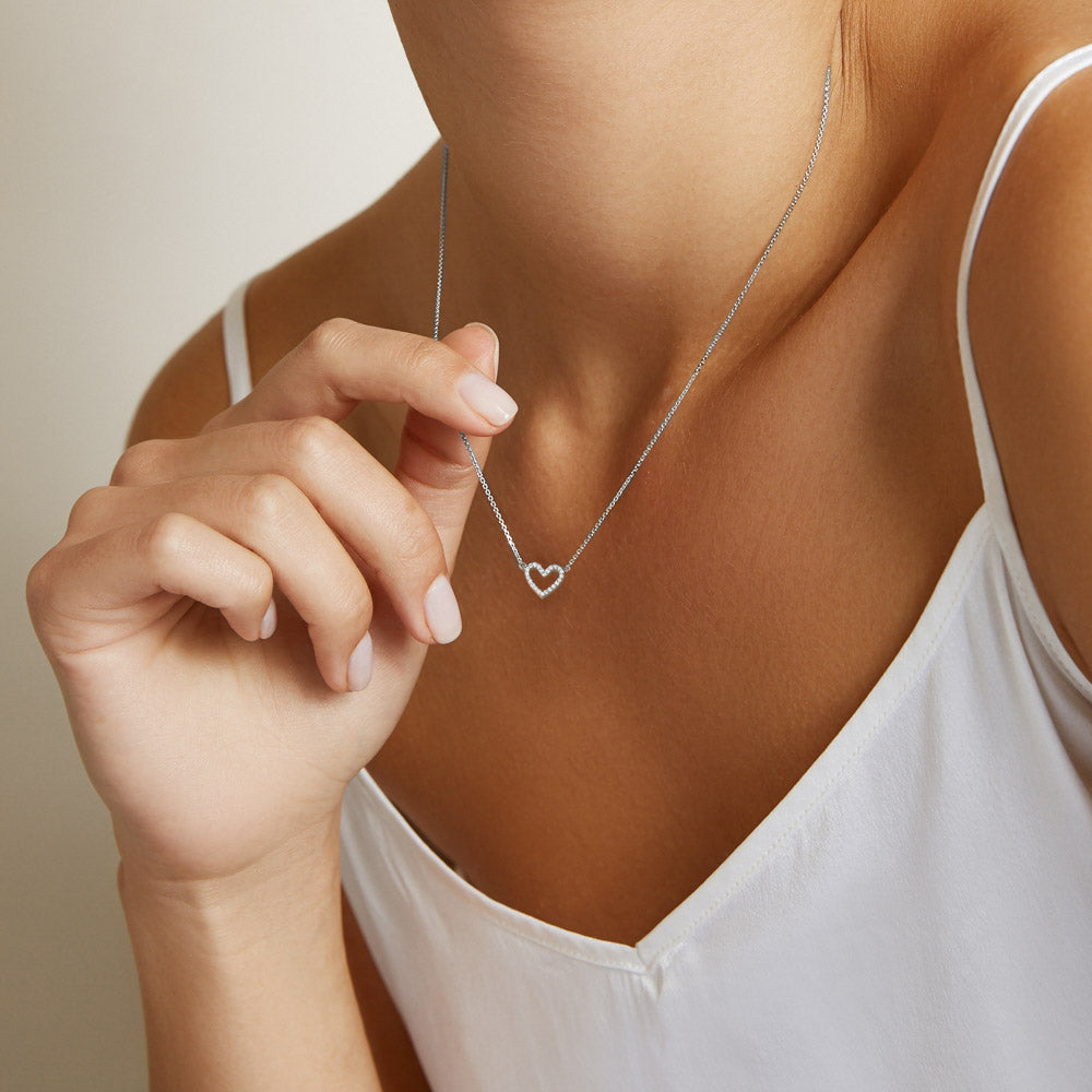 Model wearing Jewellers District's Heart Diamond Pavé Pendant Necklace in 10k White Gold #4