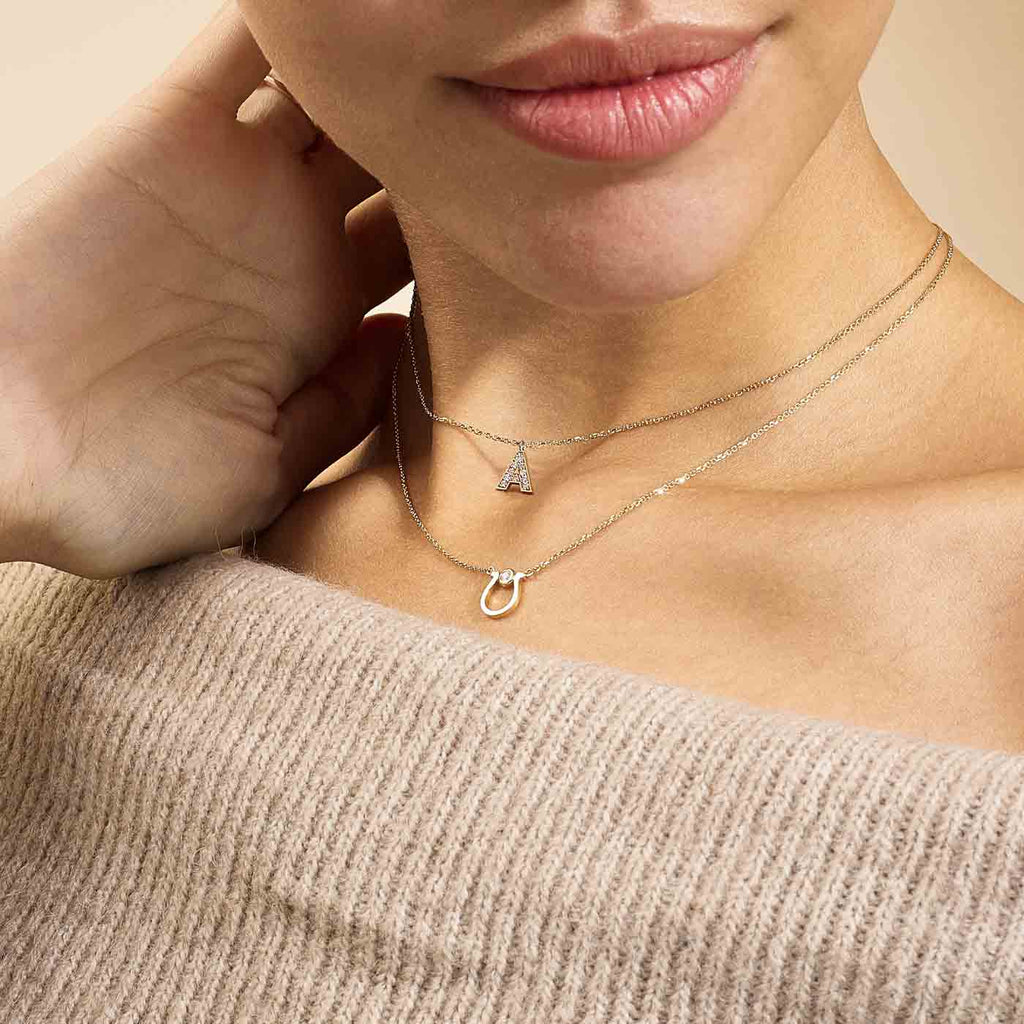 Model wearing Jewellers District's Initial Diamond Pavé Necklace : A in 14k Yellow Gold #2