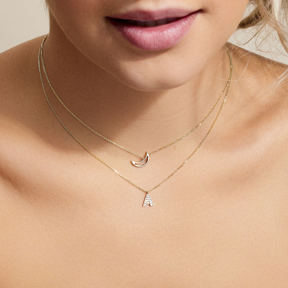 Model wearing Jewellers District's Initial Diamond Pavé Necklace : A in 14k Yellow Gold #6