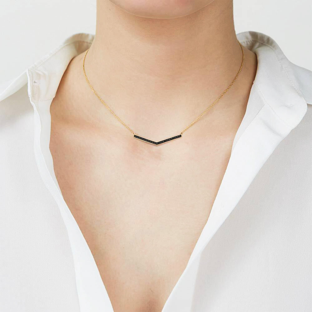 Model wearing Jewellers District's V-Shaped Gold Pendant Necklace with Black Spinels in 10k Yellow Gold #3