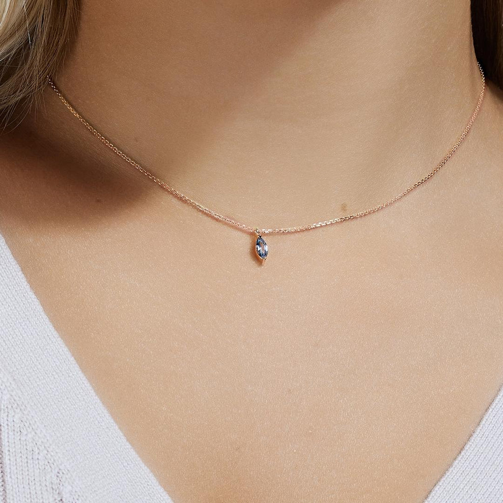 Model wearing Jewellers District's Marquise Aquamarine Pendant Necklace in 10k Rose Gold