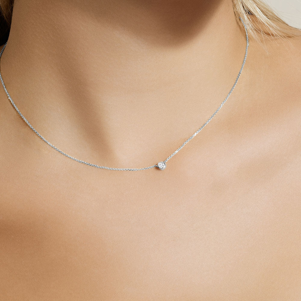 Model wearing Jewellers District's Bezel-Set Solitaire Diamond Necklace in 10k White Gold #2