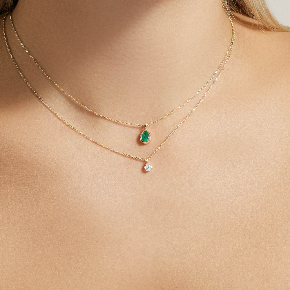 Model wearing Jewellers District's Bezel Set Pear-Cut Emerald Pendant Necklace in 14k Yellow Gold