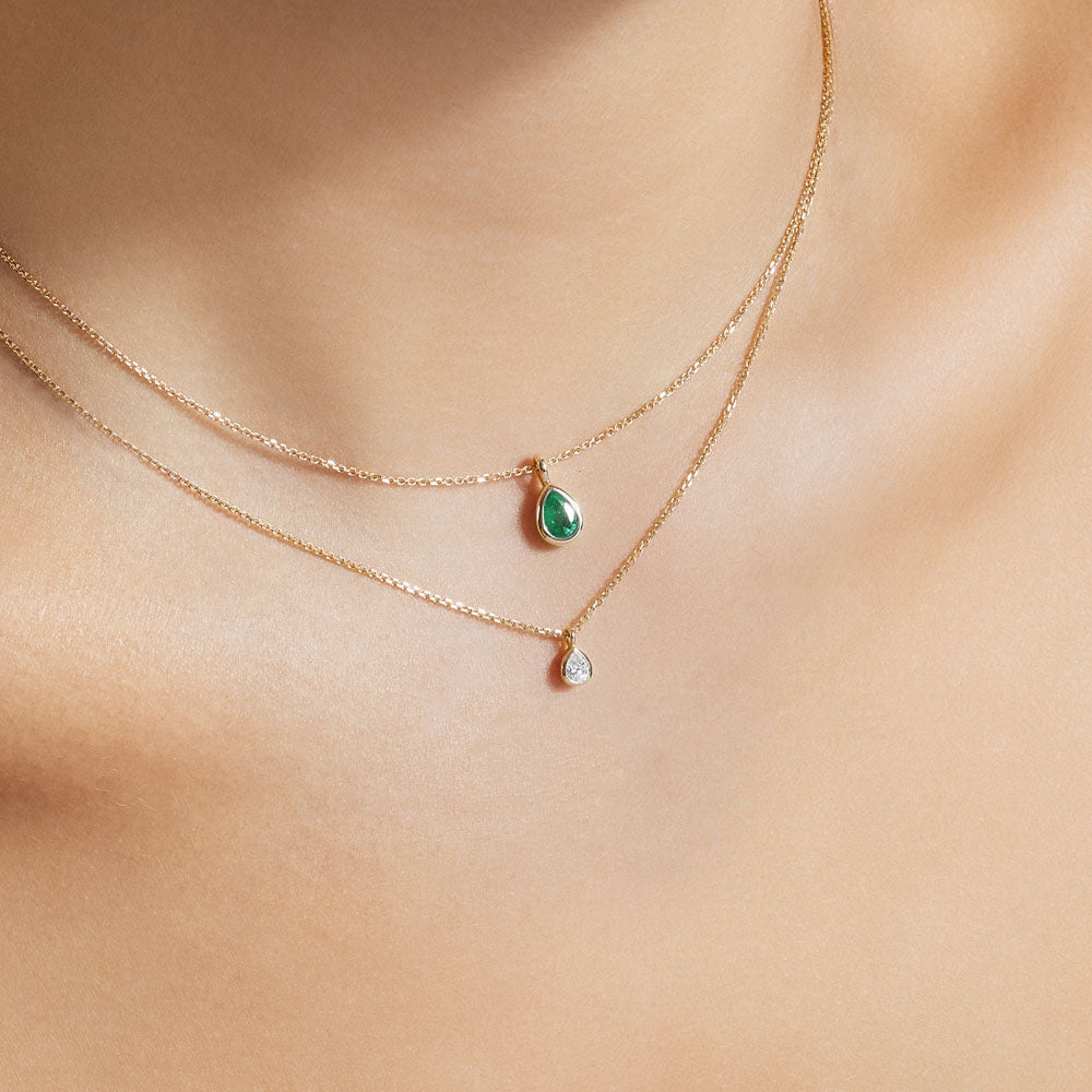 Model wearing Jewellers District's Bezel Set Pear-Cut Emerald Pendant Necklace in 14k Yellow Gold #2