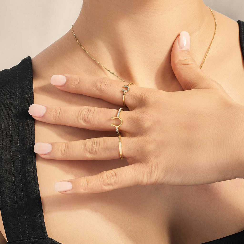 Model wearing Jewellers District's Horseshoe Gold Ring with Diamond Band in 14k Yellow Gold