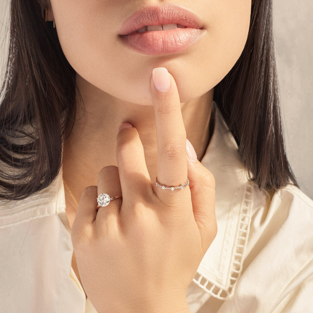 Model wearing Jewellers District's Two-Prong Diamond Wedding Ring in 14k Rose Gold