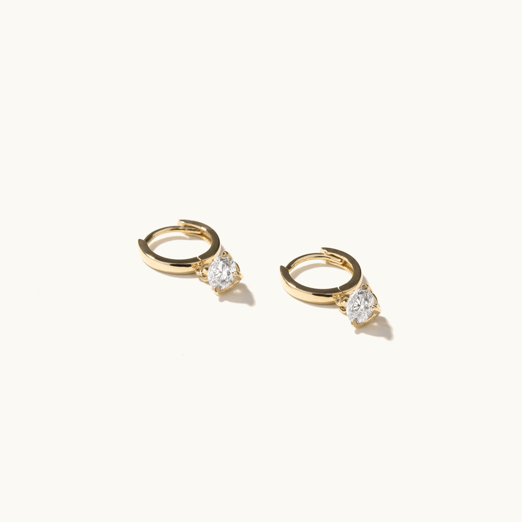 Profile view of Jewellers District's Gold Hoop Earrings with Round Cut Diamond Charm in 14k Yellow Gold