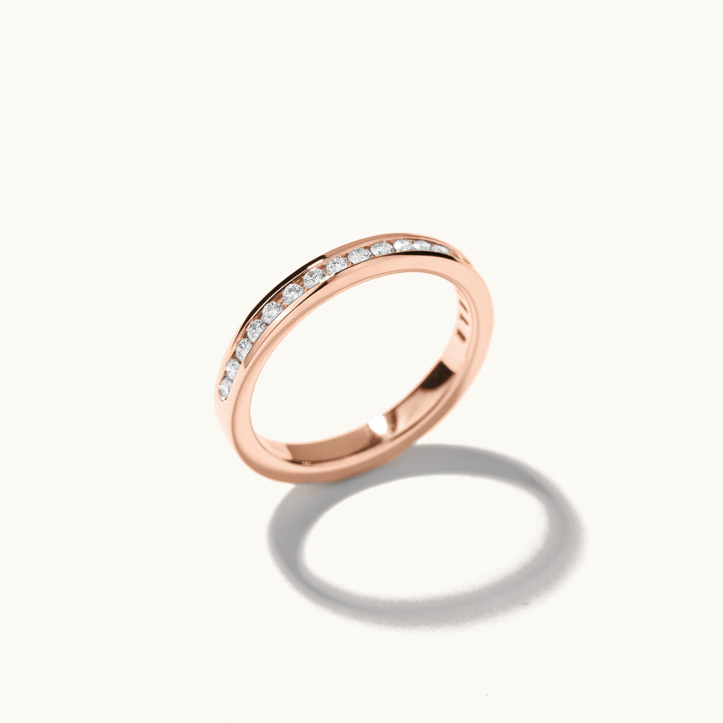 Profile view of Jewellers District's Channel-Set Diamond Pavé Wedding Ring in 14k Rose Gold