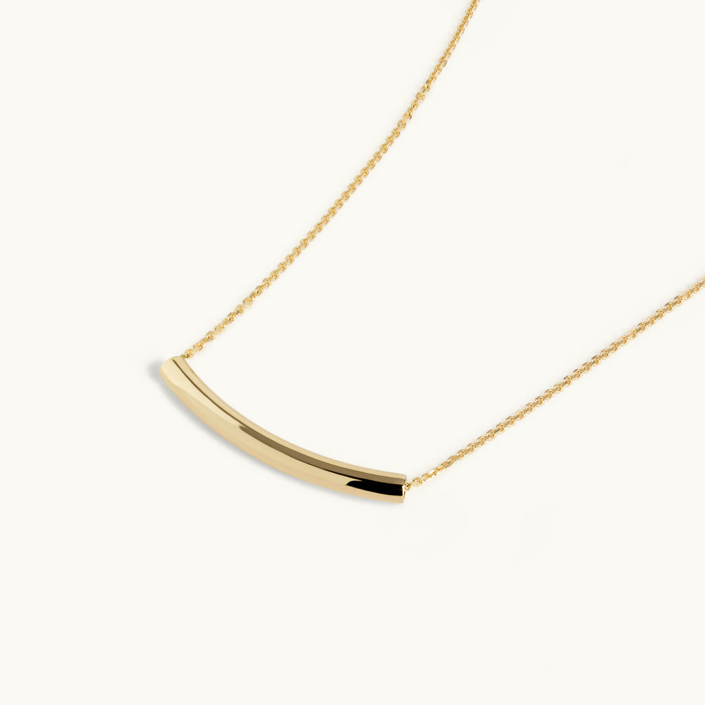 Angled view of Jewellers District's Arc of Life Curved Gold Necklace in 10k Yellow Gold